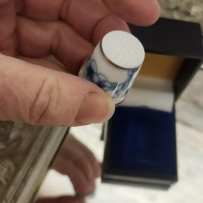 Sale Photo Thumbnail #132: Mirrored dresser tray with a pewter porringer, Hummel Girl with Geese, sleeping kitty, Bing and Grondahl thimble and a Zsolnay Bunny figurine