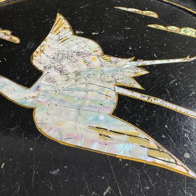 Sale Photo Thumbnail #134: These lacquered tables have mother of pearl flying cranes and clouds. The pedestals are constructed of brass and lacquered wood. There is some paint loss on the edges, and one base is not straight, and may have been bent at one time. Measurement: 16.5”H