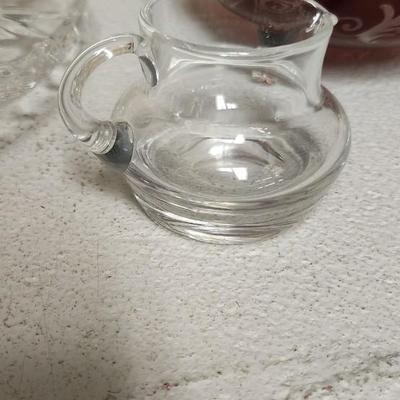 Sale Photo Thumbnail #199: Crystal cake plate, beautiful little blown creamer, vintage leaf bowl and a fantastic Egermann etched candy dish in cranberry