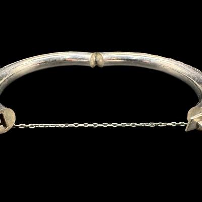 Sale Photo Thumbnail #158: [33.10g] This piece is believed to be a late 1800s Chinese export. It features chrysanthemums and leaves in high relief. It is marked “Silver” inside the hinge. The safety chain is intact. Measurement: 3”W (approximate). [JP]