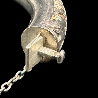 Sale Photo Thumbnail #159: [33.10g] This piece is believed to be a late 1800s Chinese export. It features chrysanthemums and leaves in high relief. It is marked “Silver” inside the hinge. The safety chain is intact. Measurement: 3”W (approximate). [JP]