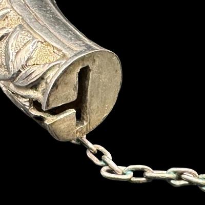 Sale Photo Thumbnail #160: [33.10g] This piece is believed to be a late 1800s Chinese export. It features chrysanthemums and leaves in high relief. It is marked “Silver” inside the hinge. The safety chain is intact. Measurement: 3”W (approximate). [JP]