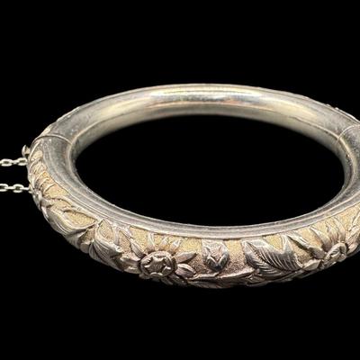 Sale Photo Thumbnail #157: [33.10g] This piece is believed to be a late 1800s Chinese export. It features chrysanthemums and leaves in high relief. It is marked “Silver” inside the hinge. The safety chain is intact. Measurement: 3”W (approximate). [JP]
