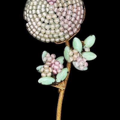 Sale Photo Thumbnail #184: This ornate costume piece was designed by Frank Hess, who also designed for Miriam Haskell. It has detailed filigree with hand blown colored glass beads and marquise cut jadeite. It was made in NYC. Measurement: 3.75”L. Pre-auction estimate: $100-$200. 