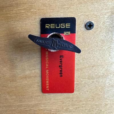 Sale Photo Thumbnail #200: Made by Reuge, in Italy. This piece has fine marquetry inlay in a floral motif, and an internal music box. Includes the original key. Measurement; 12”L x 6.5”W. Pre-auction estimate: $100-$150. [JP]