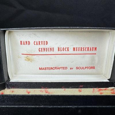 Sale Photo Thumbnail #228: Two pieces. Each is hand carved. One is unused. The amber colored piece has a crack (pictured), and may have been previously used. Two pipe stands are also included. Measurement of longest pipe: 5.75”L. [JP]