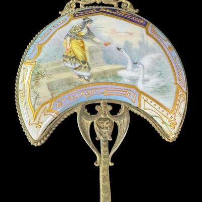 Sale Photo Thumbnail #230: Includes a porcelain Art Nouveau mirror, a brass portrait miniature mirror, and a French powder jar. Total of three pieces. There is age related wear, but all pieces are intact and unbroken. Measurement of longest: 8.75”L. Pre-auction estimate: $200-$30