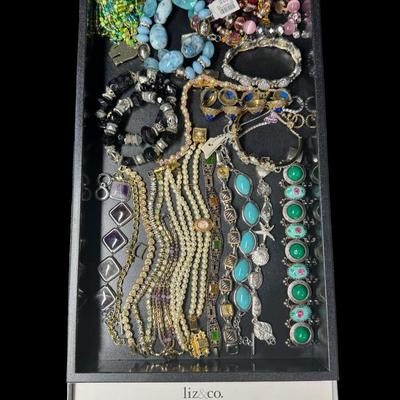 Sale Photo Thumbnail #252: Includes gold tone, silver tone, beads, stones, and more. Styles include bangle, tennis bracelet, cuff, and more. Total of 40+ pieces. Does not include display trays. [JP]