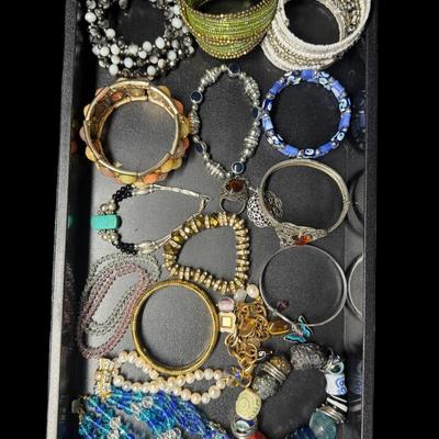Sale Photo Thumbnail #251: Includes gold tone, silver tone, beads, stones, and more. Styles include bangle, tennis bracelet, cuff, and more. Total of 40+ pieces. Does not include display trays. [JP]