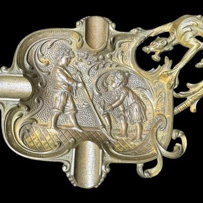 Sale Photo Thumbnail #281: Includes a European mixed metal ashtray, and a brass Danish ashtray with high relief. Age related wear, including patina. Measurement of largest: 7.25”L. Pre-auction estimate: $75-$150. [JP]