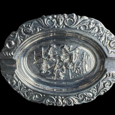 Sale Photo Thumbnail #278: Includes a European mixed metal ashtray, and a brass Danish ashtray with high relief. Age related wear, including patina. Measurement of largest: 7.25”L. Pre-auction estimate: $75-$150. [JP]