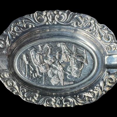 Sale Photo Thumbnail #279: Includes a European mixed metal ashtray, and a brass Danish ashtray with high relief. Age related wear, including patina. Measurement of largest: 7.25”L. Pre-auction estimate: $75-$150. [JP]