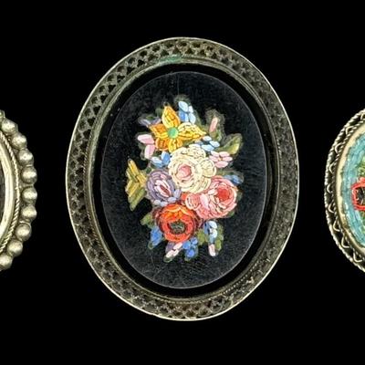 Sale Photo Thumbnail #282: Includes two “Alpacca” brooches, and one vintage brooch with a tested 800 silver filigree border. The vintage piece is missing the pin, and has age related wear. The mosaic on all three pieces appears to be intact. Measurement of largest: 2”W. Silve