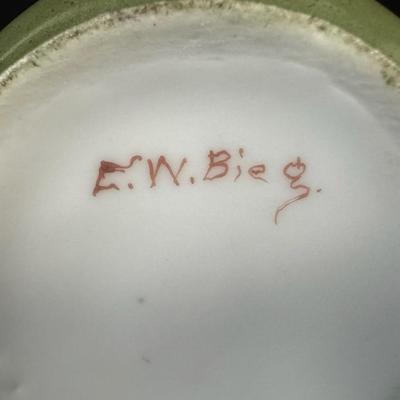 Sale Photo Thumbnail #308: Includes a console dish, and a bud vase. The bud vase has the artist’s signature on the base, and the console dish was made by Depose’ of Austria. There may or may not be flea bites or cracks in the glaze only. Measurement of longest: 8”L. [JP]