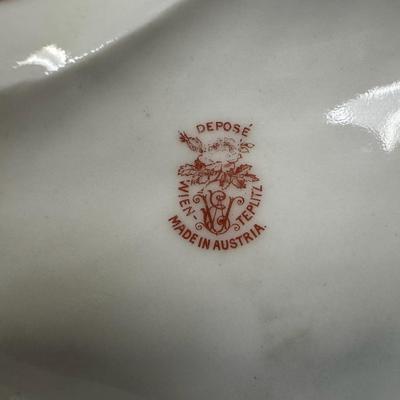 Sale Photo Thumbnail #306: Includes a console dish, and a bud vase. The bud vase has the artist’s signature on the base, and the console dish was made by Depose’ of Austria. There may or may not be flea bites or cracks in the glaze only. Measurement of longest: 8”L. [JP]