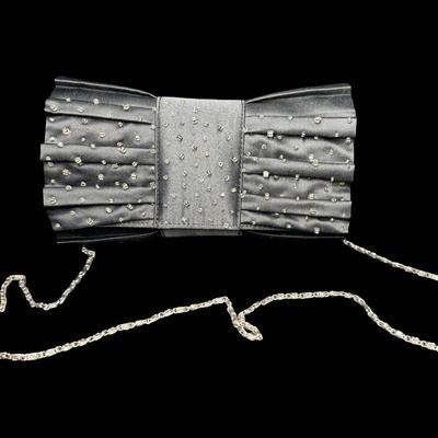 Sale Photo Thumbnail #324: Includes Nine West, Coach, Braciano, and more. Total of four pieces. Styles include wristlet, clutch, and more. There is age related wear, with no signs of serious damage or staining. Pre-auction estimate: $50-$100. [JP]