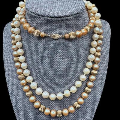 Sale Photo Thumbnail #326: Includes a hand-knotted pearl necklace, and a necklace with faux pearls and gold tone metal beads. Both necklaces have clasps that are stamped “14K.” Measurement of longest: 30”L. [JP]