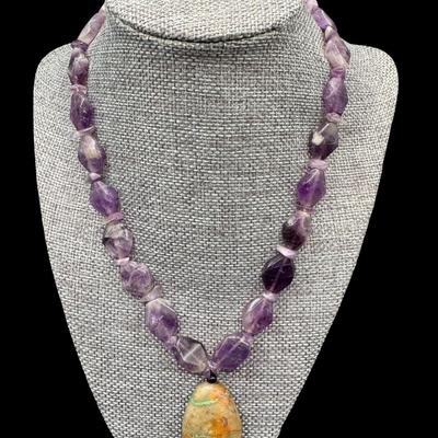 Sale Photo Thumbnail #342: This necklace features amethyst beads, and a raw turquoise pendant. The clasp is marked “925.” The designer is unknown. Measurement: 18”L. [JP]