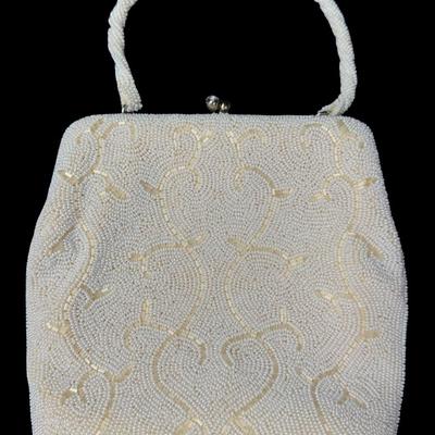 Sale Photo Thumbnail #365: Made in Japan. This bag comes with the original box. It features intricate all-over white seed beading. It has a twist clasp closure with rhinestone cabochon stones. This purse still maintains its vibrant look and appeal. Pre-auction estimate: $50-$100. [