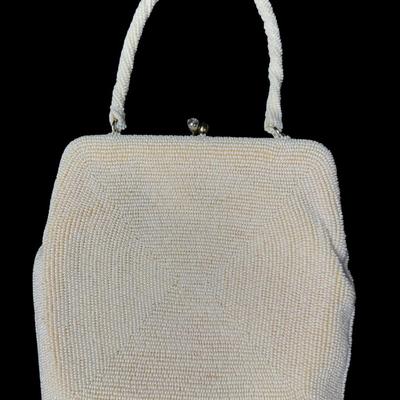 Sale Photo Thumbnail #366: Made in Japan. This bag comes with the original box. It features intricate all-over white seed beading. It has a twist clasp closure with rhinestone cabochon stones. This purse still maintains its vibrant look and appeal. Pre-auction estimate: $50-$100. [