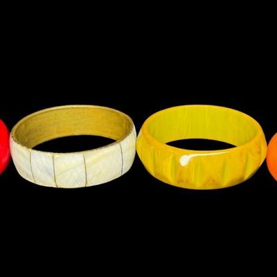 Sale Photo Thumbnail #367: Includes Bakelite, lucite, and mother of pearl bangle bracelets. Total of four pieces. These are most likely from the 1960s. Diameters range from 2.5” to 2.75”. [JP]