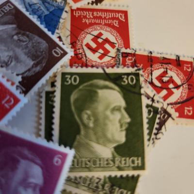 Sale Photo Thumbnail #186: This lot is for Collection of Third Reich Era Stamps,  The stamps show Hitler, Swastika and other Third Reich Symbols.  Some are unused, some have cancellation marks. There appears to be at least 30 stamps in the grouping.