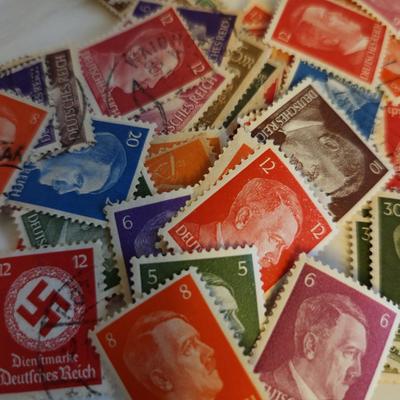 Sale Photo Thumbnail #187: This lot is for Collection of Third Reich Era Stamps,  The stamps show Hitler, Swastika and other Third Reich Symbols.  Some are unused, some have cancellation marks. There appears to be at least 30 stamps in the grouping.