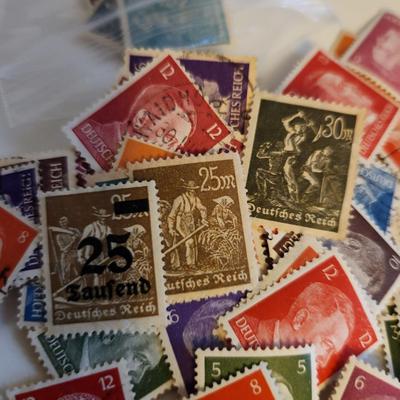 Sale Photo Thumbnail #188: This lot is for Collection of Third Reich Era Stamps,  The stamps show Hitler, Swastika and other Third Reich Symbols.  Some are unused, some have cancellation marks. There appears to be at least 30 stamps in the grouping.