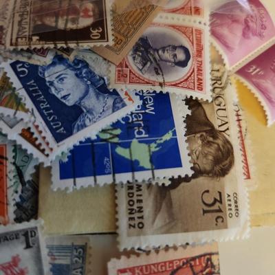 Sale Photo Thumbnail #192: This lot is for a Bag of Vintage World Stamps,  These stamps are mostly used and have cancellation marks  Stamps are from England, Thailand, Italy, Rodesia, the Maldives and other.  Nice starter group for most any interested collector - would make some gr