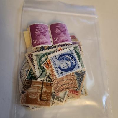 Sale Photo Thumbnail #189: This lot is for a Bag of Vintage World Stamps,  These stamps are mostly used and have cancellation marks  Stamps are from England, Thailand, Italy, Rodesia, the Maldives and other.  Nice starter group for most any interested collector - would make some gr