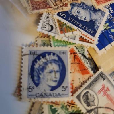 Sale Photo Thumbnail #191: This lot is for a Bag of Vintage World Stamps,  These stamps are mostly used and have cancellation marks  Stamps are from England, Thailand, Italy, Rodesia, the Maldives and other.  Nice starter group for most any interested collector - would make some gr
