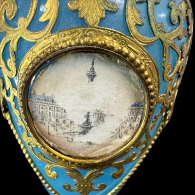 Sale Photo Thumbnail #383: This has gilt bronze mounts. The plastic cover is missing off one of the photos. Measurement: 10.5”H. Pre-auction estimate: $100-$200. [JP]