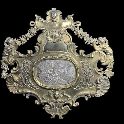 Sale Photo Thumbnail #414: Includes a dore’ tazza, and a brass European wall plaque with sterling silver insert. The wall plaque outside of the silver medallion in the center tests 70% silver, but has a brass appearance. Both pieces have age related wear. Measurement of largest: 