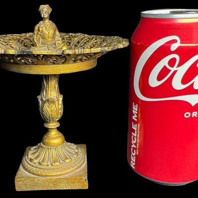 Sale Photo Thumbnail #413: Includes a dore’ tazza, and a brass European wall plaque with sterling silver insert. The wall plaque outside of the silver medallion in the center tests 70% silver, but has a brass appearance. Both pieces have age related wear. Measurement of largest: 