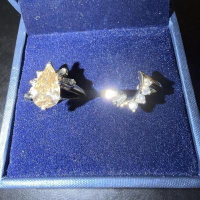 Sale Photo Thumbnail #14: 14K yellow gold and diamond pair of stacking rings feature a fancy brown pear-shaped brilliant diamond with baguette diamond and round brilliant diamond melee. The primary stone is valued at $9423.00
Additionally, there are melee diamonds between the two 