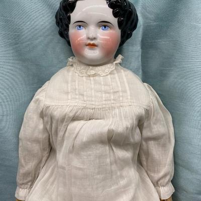 Sale Photo Thumbnail #26: This beauty has a cloth body , lace dress, leather hands, porcelain/China head and shoulders, blue eyes.
22 inches long.  Did she cross the prairie in a covered wagon?