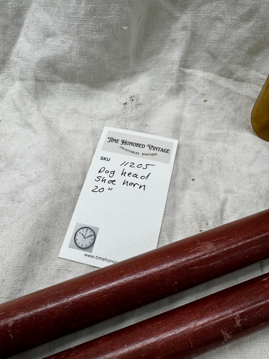 Sale Photo Thumbnail #551: Dog head (resin) with shell horn, marked with a drop of paint, Taiwan Brass Dog head stick breaks apart and top containes a corked glass vial , under that is a spring, and then the bottom third screws off too!