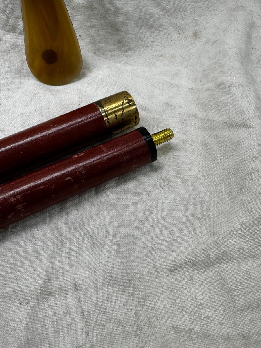 Sale Photo Thumbnail #550: Dog head (resin) with shell horn, marked with a drop of paint, Taiwan Brass Dog head stick breaks apart and top containes a corked glass vial , under that is a spring, and then the bottom third screws off too!