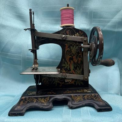 Sale Photo Thumbnail #92: With hand crank mechanism and decorative floral stenciling.   pre-1930
6 3/4 inches tall, 6 inches wide