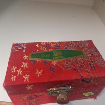 Chinese Baoding balls, also known as Chinese stress balls, meditation balls, or health balls, presented in a red silk box. 