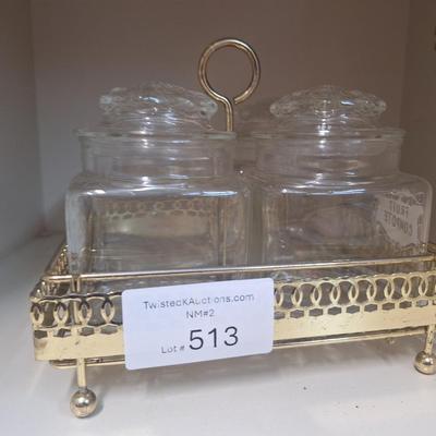 set of four glass apothecary jars in gold tone metal holder caddy, jars have etched design see all photos.