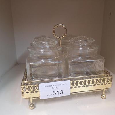 set of four glass apothecary jars in gold tone metal holder caddy, jars have etched design see all photos.