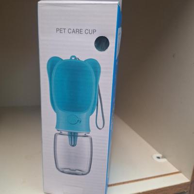 portable pet water bottle, hold it sideways so dog can lap water