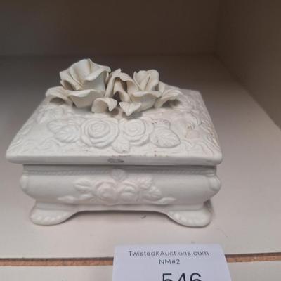 vintage ceramic or porcelain footed trinket box featuring an embossed rose design and three-dimensional roses on the lid. 