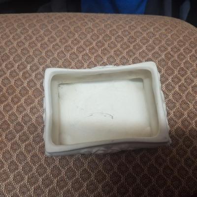 vintage ceramic or porcelain footed trinket box featuring an embossed rose design and three-dimensional roses on the lid. 