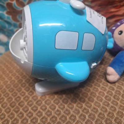 stuffed astronaut and a toy bubble maker shaped like a helicopter