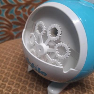 stuffed astronaut and a toy bubble maker shaped like a helicopter