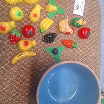 collection of vintage fruit and vegetable-themed refrigerator magnets and a pottery bowl to keep them in.