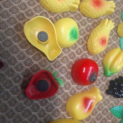 collection of vintage fruit and vegetable-themed refrigerator magnets and a pottery bowl to keep them in.