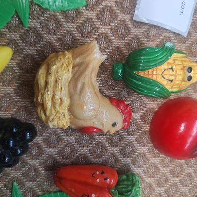 collection of vintage fruit and vegetable-themed refrigerator magnets and a pottery bowl to keep them in.